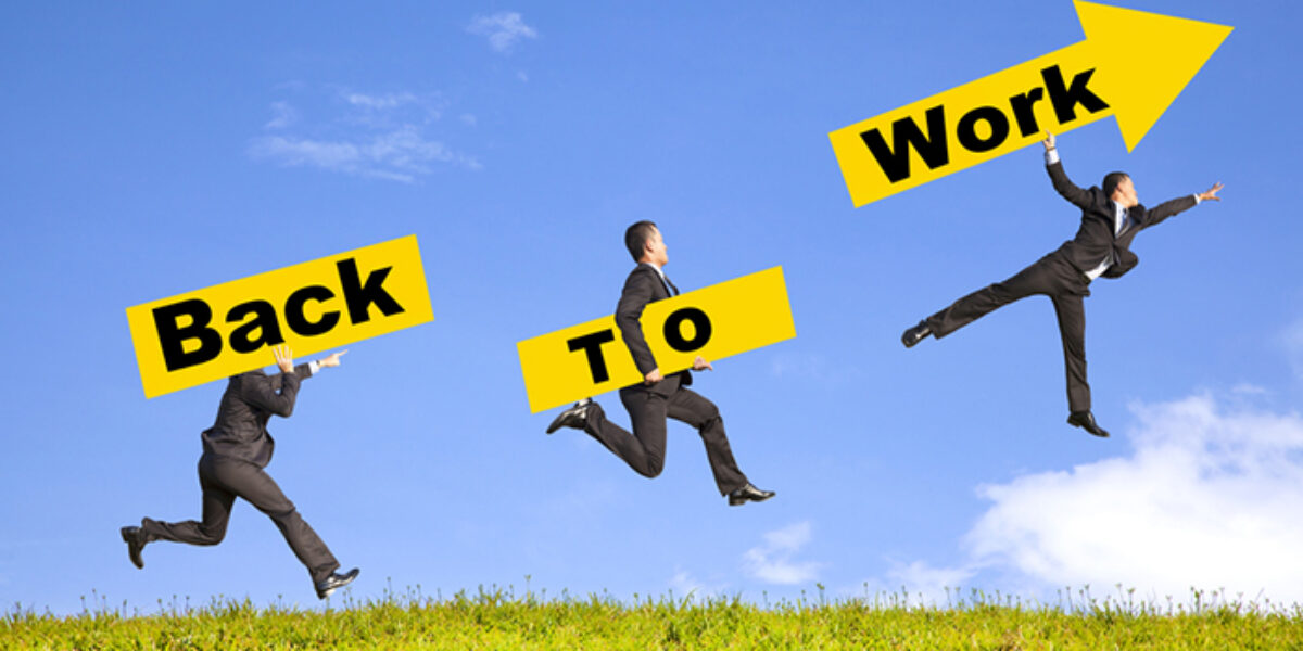businessman holding signboard show back to work